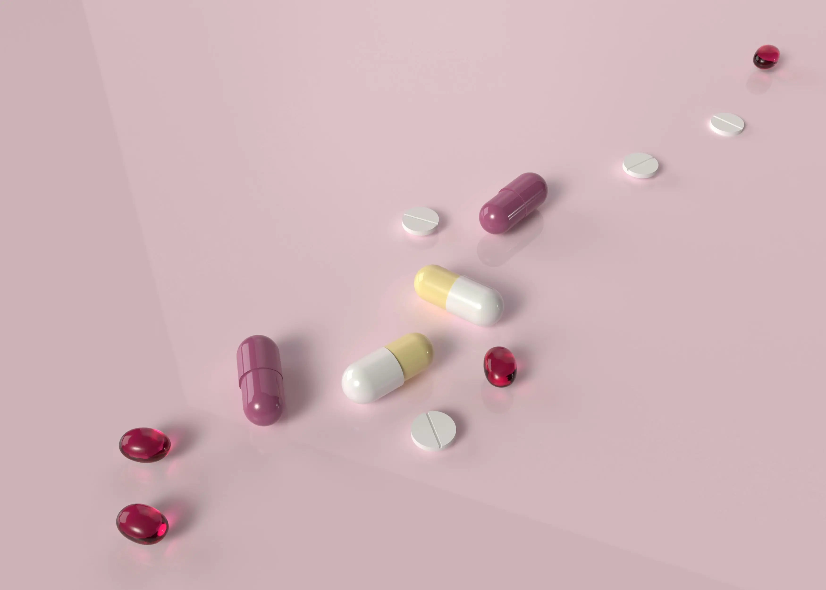 A variety of quercetin capsules, allergy relief tablets, and softgels scattered across a pastel pink surface, illustrating different supplement forms for dosage and synergistic combinations.
