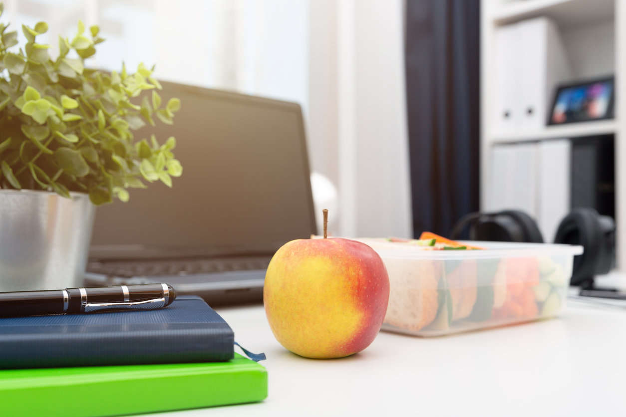 Healthy eating sandwich in a lunchbox and red apple