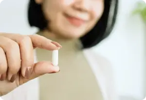 partiqlar - woman holding longevity supplements