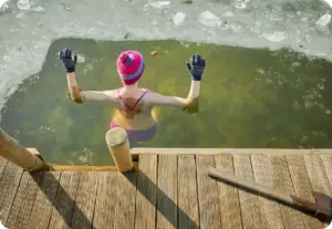 woman taking a dip in cold lake