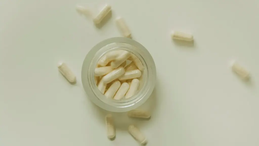 white supplements in glass bottle