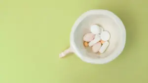 a cup filled with colorful supplements