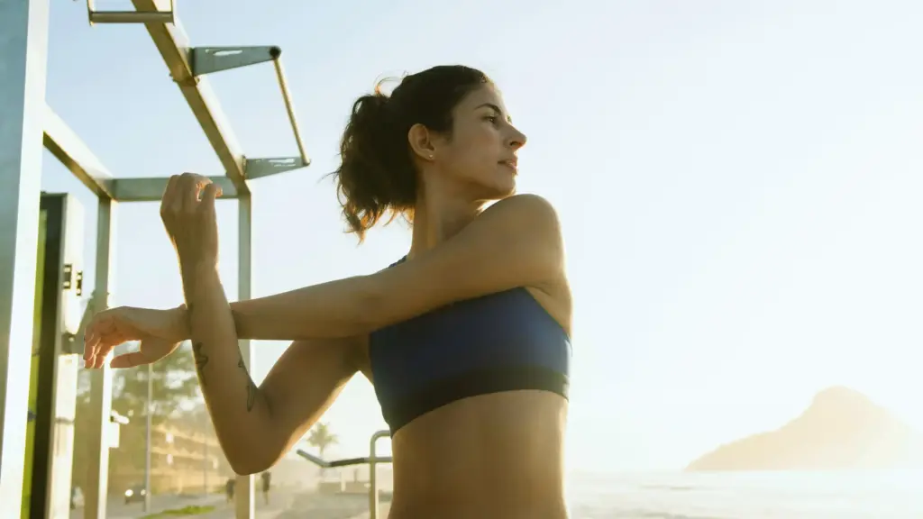 A woman stretching outdoors at sunset