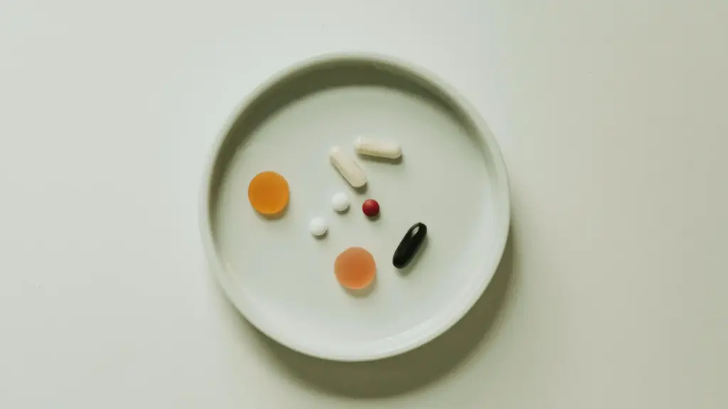 A plate with an assortment of colorful supplement capsules