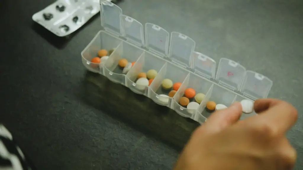 A weekly pill organizer filled with various vitamins, sorted by day of the week