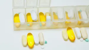 Various supplements neatly arranged in a weekly pill organizer