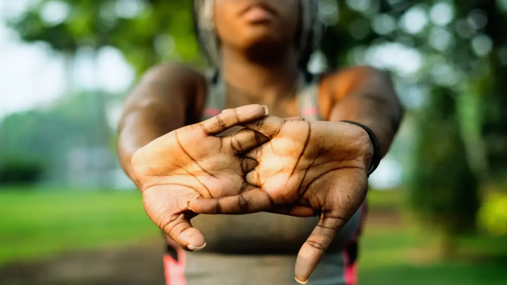 A woman stretching her hands before a workout, preparing for exercise