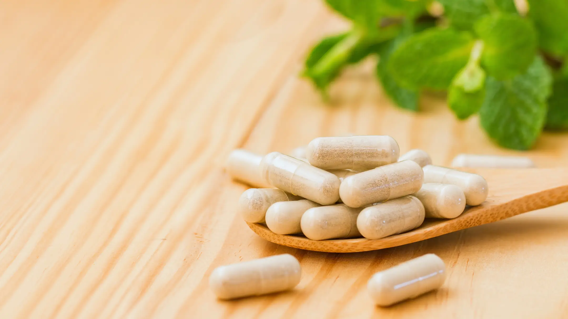 Capsules arranged on a wooden spoon