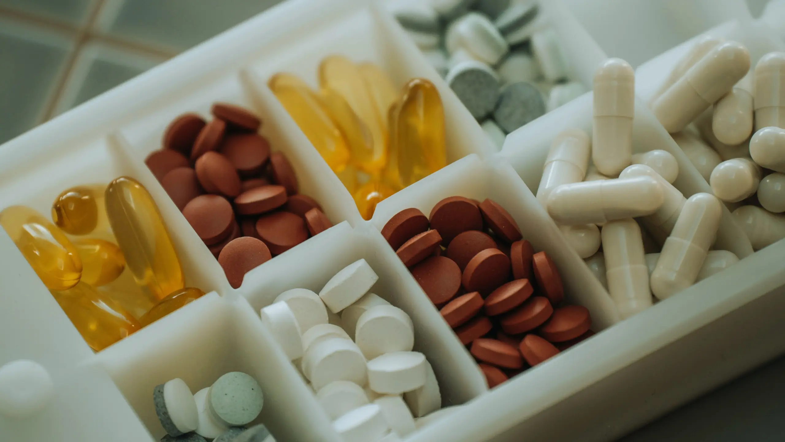 variety of supplements placed in a pill holder