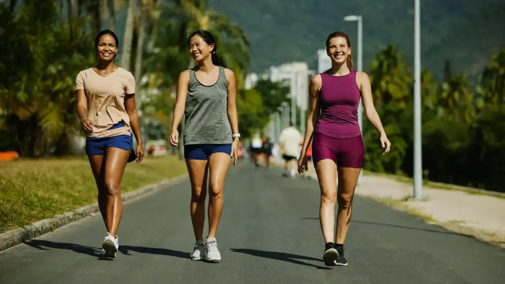 Three women exercising outdoors in a natural setting